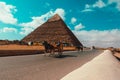 Cairo Egypt December 2021 View of a horse chariot riding in front of the great pyramids of giza. Popular tourist ride around the