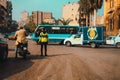 Cairo Egypt December 2021 Young police officer standing in the middle of an intersection in cairo directing traffic on a busy