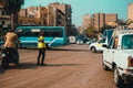 Cairo Egypt December 2021 Young police officer standing in the middle of an intersection in cairo directing traffic on a busy