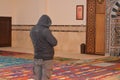 A religious Muslim man praying inside a mosque that is under construction, there are five Islamic prayers everyday for Muslims Royalty Free Stock Photo