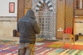 A religious Muslim man praying inside a mosque that is under construction, there are five Islamic prayers everyday for Muslims Royalty Free Stock Photo