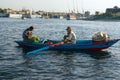 Cairo, Egypt February 18, 2017: Two Arab fishermen in a small boat typical of the Nile River, one paddling and the other crouching