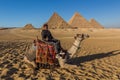 CAIRO, EGYPT - JANUARY 28, 2019: Camel rider in front of the Great pyramids of Giza, Egy Royalty Free Stock Photo