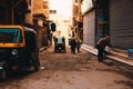 Cairo Egypt January 2022 Several tuk tuk rikshaws on a small street in suburban cairo. Poverty and trash on the streets, people Royalty Free Stock Photo