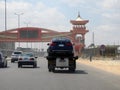 Cairo, Egypt, March 15 2023: A tow recovery transporter hydraulic flatbed truck moving BMW 320i car moving in the street Shinzo Royalty Free Stock Photo