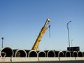 Cairo, Egypt, May 4 2023: A mobile crane ready for placing large 2500mm water pipe parts in place, sanitation pipes, improvement