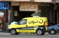 Cairo, Egypt, November 25 2022: Noon online shopping delivery yellow van to deliver a package, Arabic Translation (Noon.com