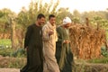 Three Egyptian men walking along the country side