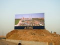 A large Advertisement LCD LED TV on a sand hill for TMG Talaat Moustafa Group, one of the largest conglomerates in Egypt Royalty Free Stock Photo