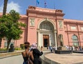 Cairo, Egypt - September 30, 2021: View of the Cairo National Egyptian Museum against the blue sky. Groups of people stand near