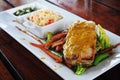 Cajun grilled salmon fillet. Rice pilaf, steamed organic vegetables, bell peppers, pumpkin, carrots and zucchini are served.