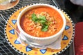 Cajun one pot jambalaya soup with chicken, shrimp, sausage, vegetables and rice, Creole dish in a bowl on a colorful plate