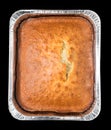 Cake baked in the form of thick aluminum foil on a black background Royalty Free Stock Photo