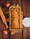 Cake in baking mold with rolling pin rural rustic wooden background flat lay. Pastry dough recipe ingredients with eggs Royalty Free Stock Photo