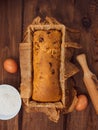 Cake in baking mold with rolling pin rural rustic wooden background flat lay. Pastry dough recipe ingredients with eggs Royalty Free Stock Photo