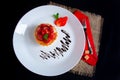 appetizing strawberry tartlet glazed with clear jelly, on a white plate with chocolate icing Royalty Free Stock Photo