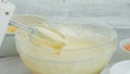 Cake batter in a glass bowl close-up on a kitchen table Royalty Free Stock Photo