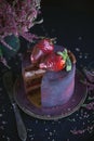 Cake with berries, covered with blue-violet glaze and chocolate with flowers, Cosmic cake, Hand Made pastry, Dark background, Sele Royalty Free Stock Photo