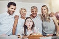 Cake, birthday and big family with girl blowing out candles for wish, party or celebration event. Love, food and kid Royalty Free Stock Photo