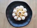 Cake on black plate and wooden table. Cake tart. Cooking sweets at home.