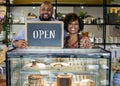 Cake cafe owners with open sign Royalty Free Stock Photo
