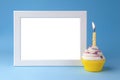 Cake with candle and photo frame on blue background closeup Royalty Free Stock Photo