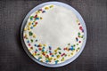 Cake candy sprinkles on a gray background. The view from the top of the cake standing on the table. Pastries are handmade on a