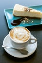 Cake and cappuccino coffee on the table Royalty Free Stock Photo