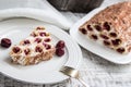 cake with cherries, cream and chocolate on a light wooden background