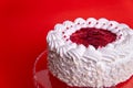 Cake with cherry isolated on white background. Piece of cheesecake with red fruits. White birthday cake on a red Royalty Free Stock Photo