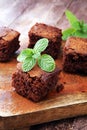 Cake chocolate brownies on wooden background with mint.