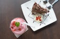 Cake chocolate with strawberry smoothie in cafe.