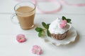 Cake and Coffee. Tasty cake with cream and pink flower decor in white plate. Good morning. Perfect breakfast