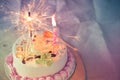Cake with colorful sprinkles and a sparkler Royalty Free Stock Photo