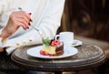 Cake with cream delicious dessert. Appetite concept. Dessert cake cup of coffee and female hand with fork close up