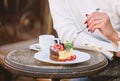 Cake with cream delicious dessert. Appetite concept. Dessert cake cup of coffee and female hand with fork close up