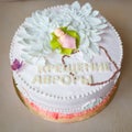 Cake with cream flowers and mastic baby figure for girl christening party.