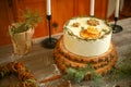 Cake Decorated With Dried Oranges And Cookies In The Form Of Snowflakes On A Wooden Table With Christmas Decorations.
