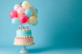 A cake decorated with a festive arrangement of colorful balloons on top, ready for a celebration, Balloons in the shape of a Royalty Free Stock Photo