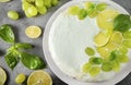 1 cake decorated with grapes, lime slices, and green Basil on a gray background, baking, pie, top view, citrus