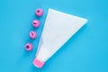 Cake decorating tools on blue background. White pastry bag with pink plastic nozzles for decoration baking