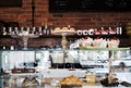 Cake display case in Melbourne cafe with rustic wall