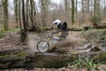 Cake electric off-road motorcycle through deep water at speed, Surrey, England