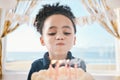 Cake, face and girl child blowing candles at birthday, celebration or special event in her home. Party, dessert and kid Royalty Free Stock Photo