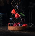 Cake with fresh berries and chocolate sauce , food levitation on dark background