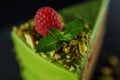 Cake with fruity cream and pistachio decorated with nuts, isolated