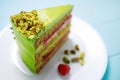 Cake with fruity cream and pistachio decorated with nuts, isolated