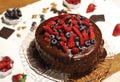 Chocolate cake with berries. With ingredients on the table.