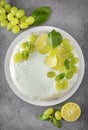 Cake with grapes, lime slices, green Basil on a gray background, baking, pie, top view, citrus