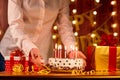 Cake Happy Birthday with candles and hand of the girl on backgr Royalty Free Stock Photo